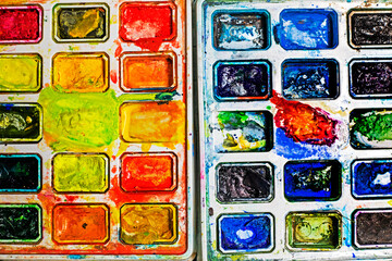 watercolor paints in warm and cold colors flatlay