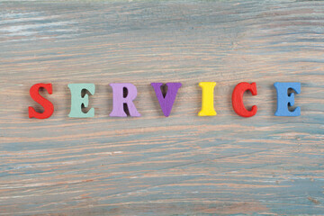 SERVICE word on wooden background composed from colorful abc alphabet block wooden letters, copy...