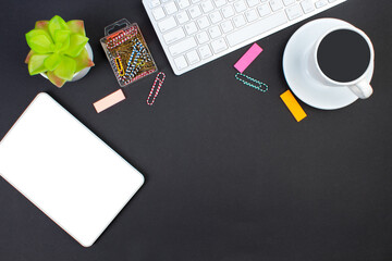 black office table with computer, pen and a cup of coffee, lot of things. Top view with copy space.