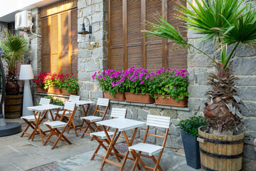 Empty tables on the traditional street in the old town of Nessebar, Bulgaria. Ancient town on the coast of Black Sea