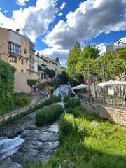 Obraz premium Waterfall in the middle of the town of Trillo in Guadalajara, Castilla la Mancha, Spain.