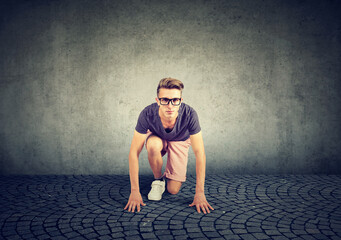 Young determined man a student ready in a start position
