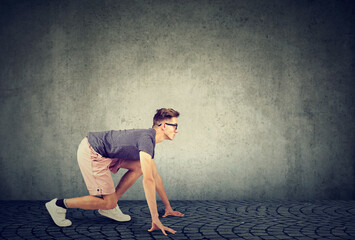 Young determined man a student ready in a start position