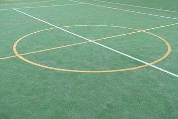 Artificial green grass carpet cover on a mini soccer playground. Artificial grass for sports...