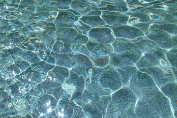 Clear water in the rays of the sun. Water background.