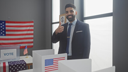 Handsome hispanic man in suit giving thumbs up in american electoral college with flag