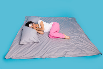 Full body portrait of pretty young woman sleep bed wear pajama isolated on blue color background