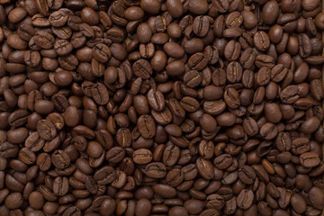 Roasted coffee beans as background, top view