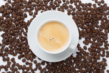 Cup of coffee on color background, top view
