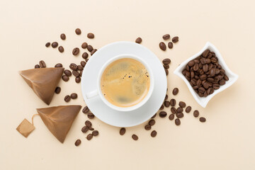 Cup of coffee made using pyramid on wooden background, top view