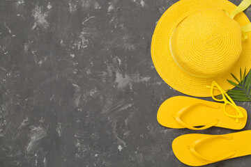 Flat lay with yellow summer outfit on concrete background. Vacation concept