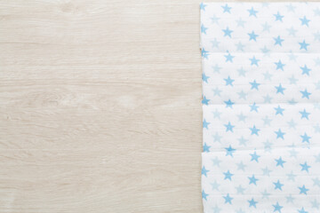 Cotton fabric on wooden background, top view