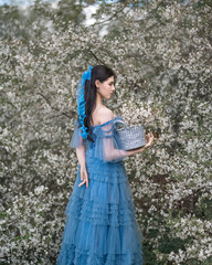 Portrait of a beautiful girl on the background of a cherry blossom