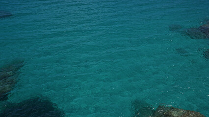 Clear, turquoise waters of torre dell'orso in salento, puglia, italy, showcasing its pristine ocean in a tranquil outdoor setting.