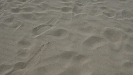Footprints in the sand on pescoluse beach in salento, puglia, italy, showcase a serene and...