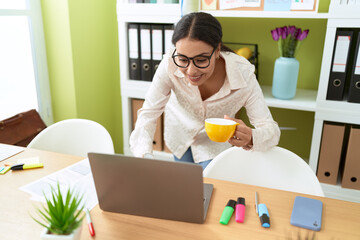 Young arab woman business worker using laptop drinking coffee at office