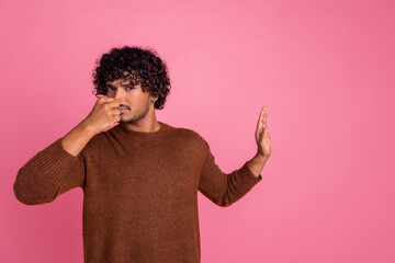 Photo of upset disappointed man wear brown clothes avoid empty space isolated on pink color...