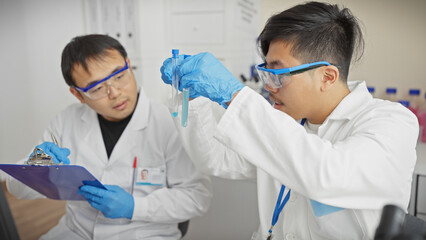 Two men in lab coats analyze samples in a science laboratory, embodying teamwork and research.