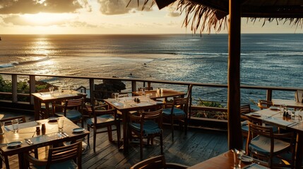 Fototapeta premium A restaurant overlooking the ocean at sunset