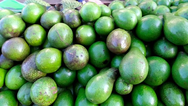 A display of Philippine ripe avocados, although it is green they are ready to eat.