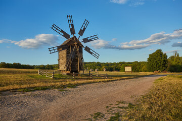 Fototapeta premium Traditional ukrainian windmill in the museum of national architecture in Pirogovo in a beautiful summer day, Kiev