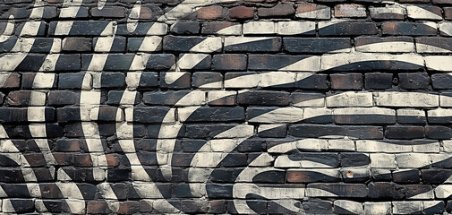 A brick wall with zebra stripes pattern. Zebra inspired graffiti on urban wall that can be used as background. Street art zebra.