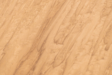 Sand mounds. Sandy natural background. Lines in the sand.