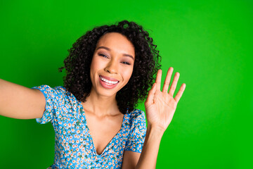 Photo of nice young woman make selfie arm wave hi wear top isolated on green color background