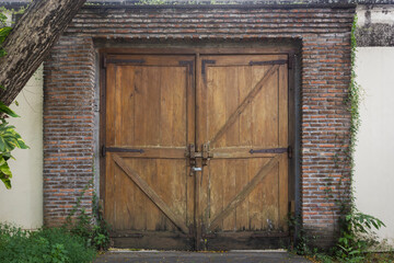 Brown Old wooden door with padlock
