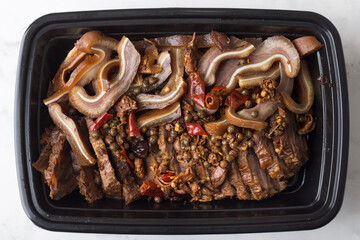 Chinese takeout food beef shanks with crispy pig ears in a container