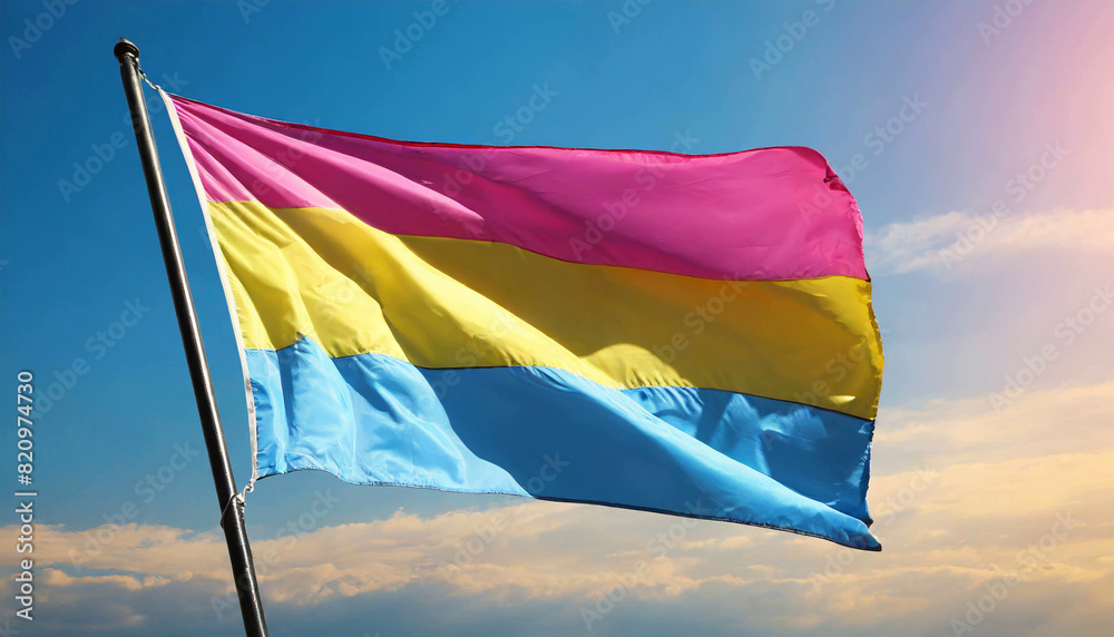 Wall mural pansexual flag flutters against blue sky, lgbtq pride month, pan