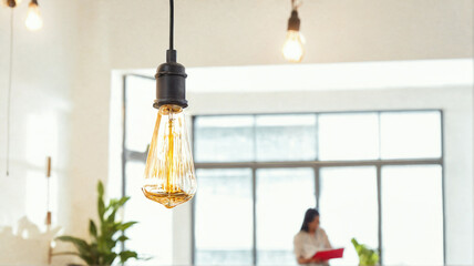 Ceiling light bulb in the bright room, co-working space