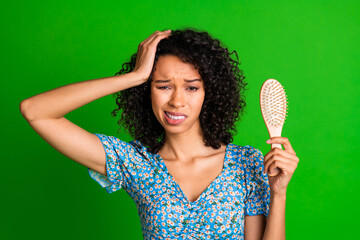 Photo of nice young woman hold brush touch head wear top isolated on green color background