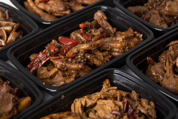 Chinese takeout food spicy duck claws with different type of Chinese food on the table