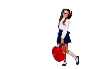 Full size body length of glad girlish shy nice smart cute small little girl with curly ponytails in white blouse shirt and blue skirt with red bag. Isolated on black background