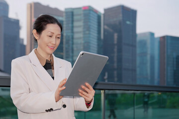 Professional Woman Using Tablet in Urban Setting