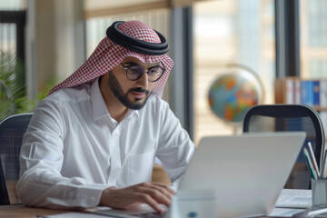Arabian entrepreneur strategizing growth plan for company.