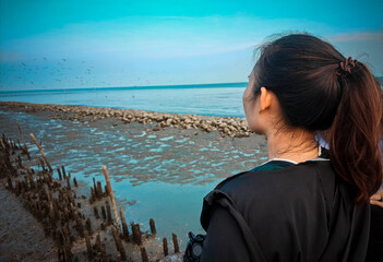 back view young woman sea  birds