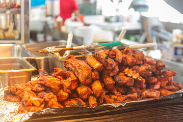 Horizontal photograph of pork ribs at a traditional Latin fair. 