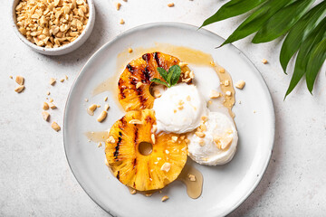 Grilled pineapples with icecream, tropical dessert