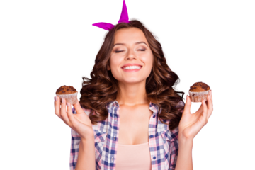 Portrait of nice girlish attractive funny wavy-haired lady wearing checkered shirt having fun holding in hands two fresh muffins closed eyes isolated over violet pastel background