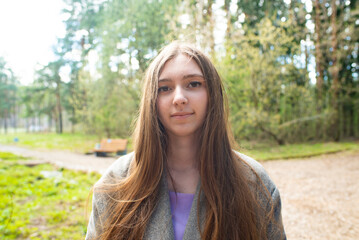  Portrait of a beautiful young girl with long hair in the forest