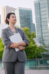 Confident Businesswoman Holding Tablet in Urban Setting