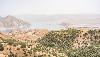 Panoramic view of the Nurek reservoir in the mountains of Tajikistan, landscape of a blue lake in...