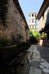 Inside the courtyard of the St., Saint Konstantin & Elena Church, the bell tower and a garden can...
