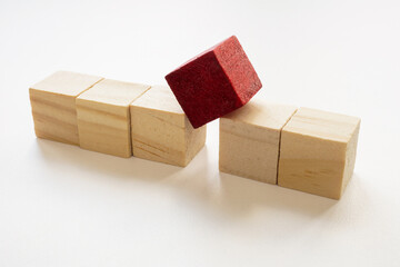 A line of cubes and a separate red one. Concept of personnel management and dismissal of a bad...