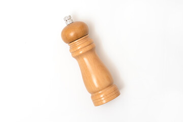 Wooden pepper mill isolated on white background, top view.
