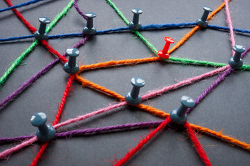 A network of colored threads connecting pins as a concept for connecting elements of a complex...