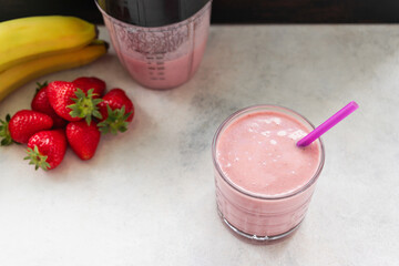 Strawberry and banana smoothie drink, blended cocktail, milkshake in a glass