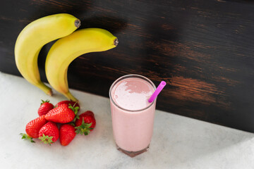 Strawberry and banana smoothie drink, blended cocktail, milkshake in a glass